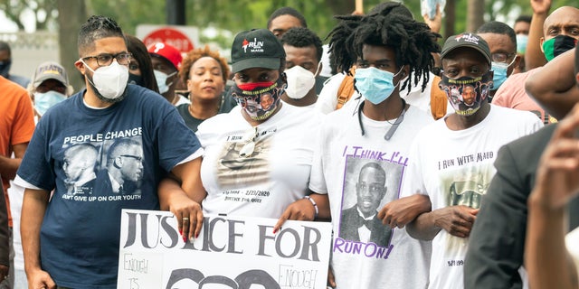 A group of protesters march from the Glynn County Courthouse to a police station after a rally to protest the shooting of Ahmaud Arbery, Saturday, May 16, 2020, in Brunswick, Ga. (AP Photo/Stephen B. Morton)