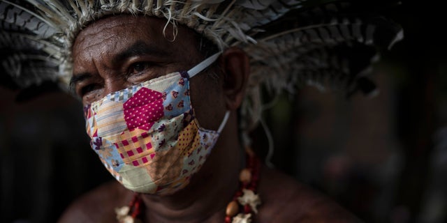 Pedro dos Santos, the leader of a community named Park of Indigenous Nations, poses for a photo, in Manaus, Brazil this May. Manaus' lack of the new coronavirus treatment prompted Pedro dos Santos to drink tea made of chicory root, garlic and lime to combat a high fever that lasted 10 days. (AP Photo/Felipe Dana)