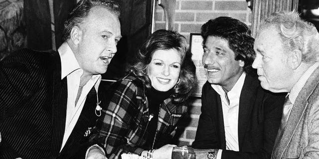 At a Super Bowl pregame taping, Phyllis George is seen with, from left, former NFL players Paul Horning and Joe Namath, and "All in the Family" star Carroll O'Connor, in Beverly Hills, Calif., Jan. 21, 1980. (Associated Press)