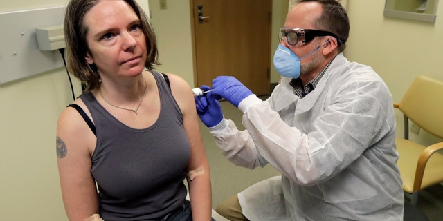 A pharmacist gives the first shot in the first-stage safety study clinical trial of a potential vaccine for COVID-19, the disease caused by the new coronavirus in Seattle on March 16, 2020. The vaccine by Cambridge, Massachusetts-based Moderna Inc., generated antibodies similar to those seen in people who have recovered from COVID-19 in a study volunteers who were given either a low or medium dose. (AP Photo/Ted S. Warren, File)