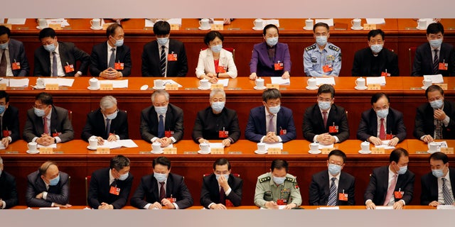 Delegates wearing face masks to protect against the spread of the new coronavirus wait for the start of the opening session of the Chinese People's Political Consultative Conference (CPPCC) at the Great Hall of the People in Beijing, Thursday, May 21, 2020. (AP Photo/Andy Wong, Pool)
