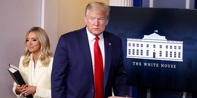 President Donald Trump arrives to speak with reporters about the coronavirus in the James Brady Briefing Room of the White House, Friday, May 22, 2020, in Washington with White House press secretary Kayleigh McEnany. (AP Photo/Alex Brandon)