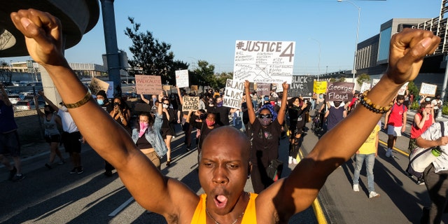 Demonstrators march during a protest of the death of George Floyd, a black man who was in police custody in Minneapolis, in downtown Los Angeles, Wednesday, May 27, 2020. (Associated Press)