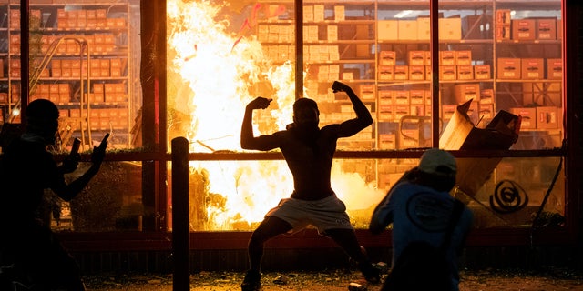 A fire was started at an AutoZone shop in Minneapolis during violent demonstrations in the wake of the death of George Floyd, a black man killed while in police custody. (Carlos Gonzalez/Star Tribune via AP)