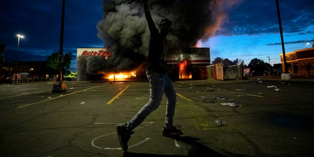 A fire was started at an AutoZone shop in Minneapolis during violent demonstrations in the wake of the death of George Floyd, a black man killed while in police custody. (Carlos Gonzalez/Star Tribune via AP)