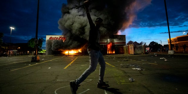 A fire was started at an AutoZone shop in Minneapolis during violent demonstrations in the wake of the death of George Floyd, a black man killed while in police custody. (Carlos Gonzalez/Star Tribune via AP)