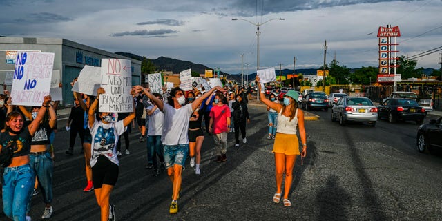 Protestors march on Central Avenue and Utah Street as cars parade and honk going east, Thursday, May 28, 2020 in Albuquerque, N.M. The march was prompted by the death of George Floyd, who dies while in the custody of Minneapolis police. (Anthony Jackson//The Albuquerque Journal via AP)