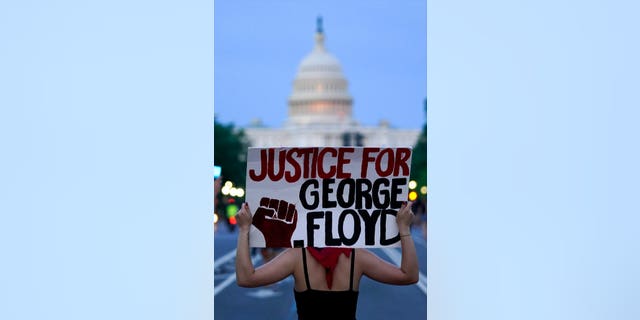 Demonstrators walk along Pennsylvania Avenue as they protest the death of George Floyd, a black man who died in police custody in Minneapolis, Friday, May 29, 2020, in Washington. (AP Photo/Evan Vucci)