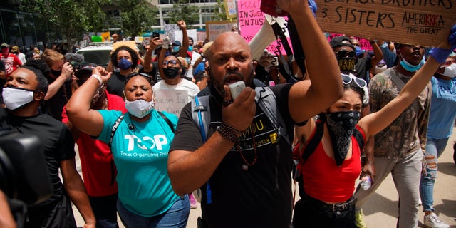 Black Lives Matter protesters rally in honor of George Floyd at Discovery Green in Houston, Friday, May 29, 2020. Floyd died Memorial Day while in the custody of the Minneapolis police. (Elizabeth Conley/Houston Chronicle via AP)