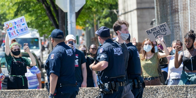 A protester is arrested for blocking traffic on the F.D.R. after marching through Harlem during a solidarity rally for George Floyd, Saturday, May 30, 2020, in New York City. (Associated Press)
