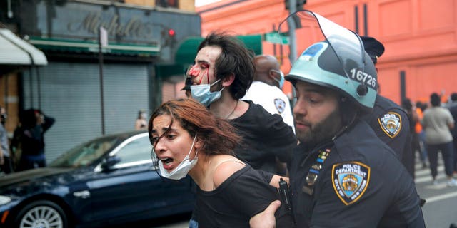 New York Police officers restrain protesters during a demonstration, Saturday, May 30, 2020, in the Brooklyn borough of New York. (AP Photo/Seth Wenig)