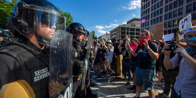 Secret Service Police officers form a block on Pennsylvania Avenue NW to prevent protesters from reaching the White House during a rally in Washington, Saturday, May 30, 2020. Demonstrations took place nationwide in protest of the Memorial Day death of George Floyd, who died in police custody in Minneapolis. (AP Photo/Manuel Balce Ceneta)