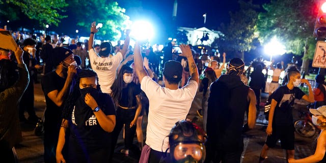 Demonstrators gather to protest the death of George Floyd, Saturday, May 30, 2020, near the White House in Washington. Floyd died after being restrained by Minneapolis police officers. (AP Photo/Evan Vucci)