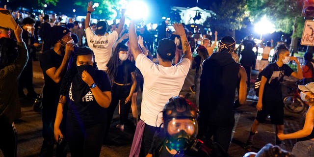 Demonstrators gather to protest the death of George Floyd, Saturday, May 30, 2020, near the White House in Washington. (AP Photo/Evan Vucci)