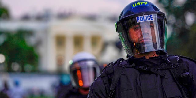 Police in riot gear stand in front of the White House as demonstrators gather to protest the death of George Floyd, Saturday, May 30, 2020, outside the White House in Washington. (AP Photo/Evan Vucci)