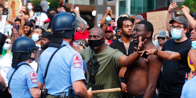 Demonstrators standing off with police in downtown Raleigh, N.C., on Saturday, during a protest over the death of George Floyd, who died in police custody on Memorial Day in Minneapolis. (Ethan Hyman/The News & Observer via AP)