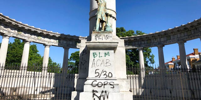 A monument to Confederate President Jefferson Davis in Richmond, Va., is covered with graffiti on Sunday, May 31, 2020, after overnight protests over the death of George Floyd. Many of the city’s most prominent Confederate monuments were tagged with similar graffiti. (AP Photo/ Sarah Rankin)