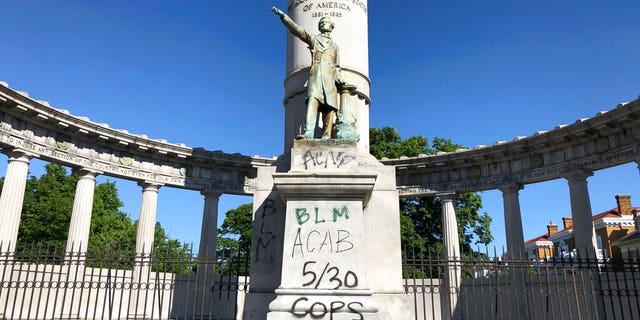 A monument to Confederate President Jefferson Davis in Richmond, Va., is covered with graffiti on Sunday, May 31, 2020, after overnight protests over the death of George Floyd. Many of the city’s most prominent Confederate monuments were tagged with similar graffiti.