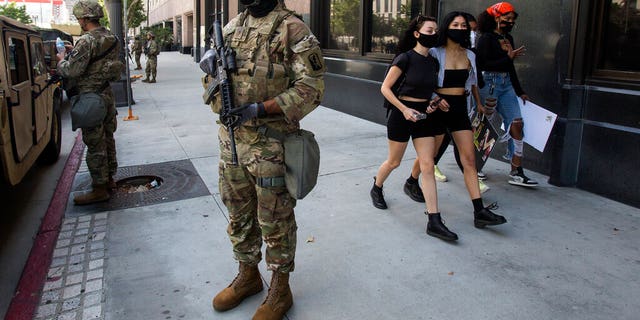 A member of the California National Guard standing watch Sunday in Los Angeles. 