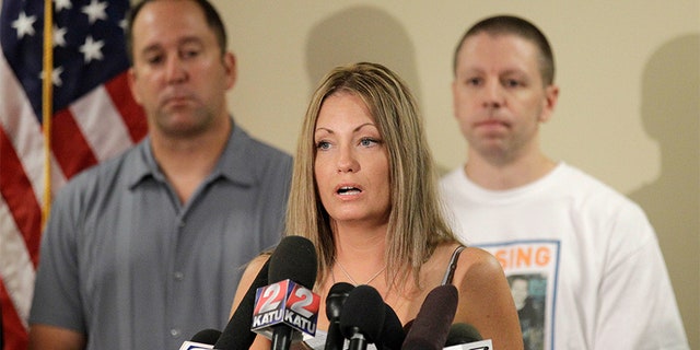 Kyron Horman's birth mother Desiree Young makes remarks during a news conference while Desiree's husband Tony Young, left, and Kaine Horman, Kyron's father, look, at the Multnomah County Sheriff's Training Facility, in Portland, Ore. Kyron Horman went missing from Skyline Elementary School June 4 and the search for him is ongoing Missing Oregon Boy, Portland, USA.