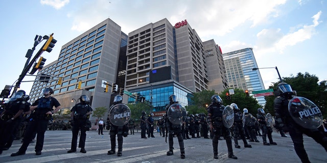 Atlanta Police, monitor demonstrators protesting, Saturday, May 30, 2020 in Atlanta.