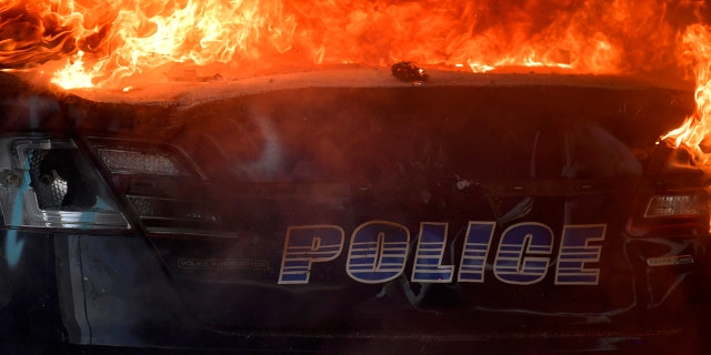 An Atlanta Police Department vehicle burns during a demonstration against police violence, Friday, May 29, 2020 in Atlanta.