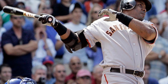 FILE - In this July 19, 2007, file photo, San Francisco Giants' Barry Bonds hits a three-run home run during the seventh inning of a baseball game against the Chicago Cubs in Chicago. (AP Photo/M. Spencer Green, File)