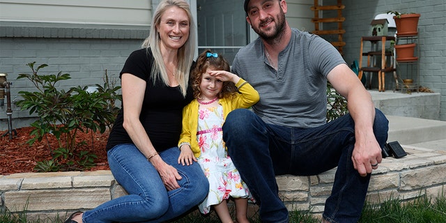 Eli Oderberg with wife Katie Evers and their 4-year-old daughter, Everlee, outside their home in southeast Denver last week. (AP Photo/David Zalubowski)