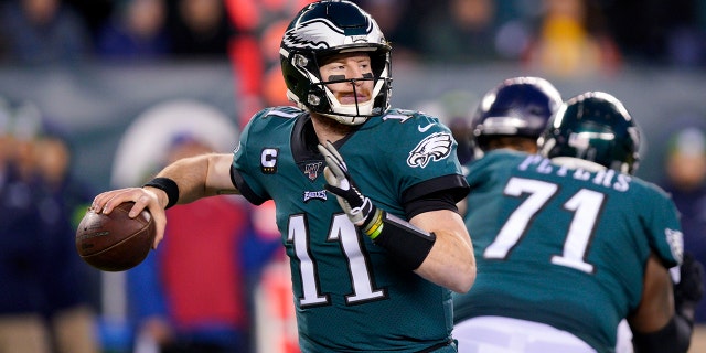 In this Jan. 5, 2020 photo, Philadelphia Eagles' Carson Wentz passes during the first half of an NFL wild-card playoff football game against the Seattle Seahawks in Philadelphia. Injuries forced Wentz to watch another quarterback lead the Eagles to their first Super Bowl title and put him on the sideline for playoff games in each of the next two seasons. (AP Photo/Chris Szagola, File)