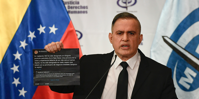 Venezuela's Attorney General Tarek William Saab holds up twitter posts during a press conference regarding what the government calls a failed attack over the weekend aimed at overthrowing President Nicolás Maduro in Caracas, Venezuela, May 4. The twitter posts are between two members of the opposition, Humberto Calderon and Yon Goicoechea. (AP Photo/Matias Delacroix)