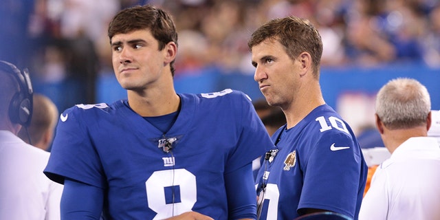 Aug 16, 2019; East Rutherford, N.J.: New York Giants quarterback Daniel Jones, No. 8, looks on with quarterback Eli Manning, No. 10, during the second half against the Chicago Bears at MetLife Stadium.