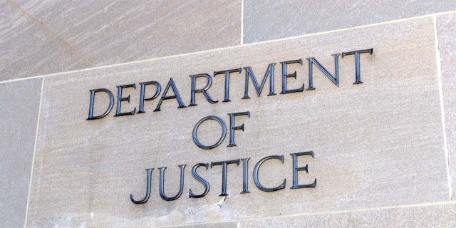 Department of Justice sign, Washington DC, USA. iStock