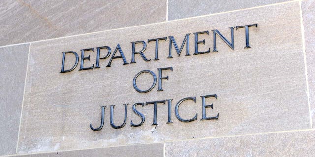 Department of Justice sign, Washington DC, USA. iStock