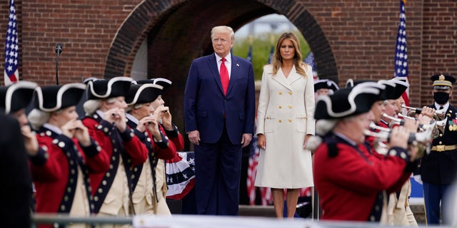 President Donald Trump and first lady Melania Trump participate in a Memorial Day ceremony at Fort McHenry National Monument and Historic Shrine, Monday, May 25, 2020, in Baltimore. (AP Photo/Evan Vucci)
