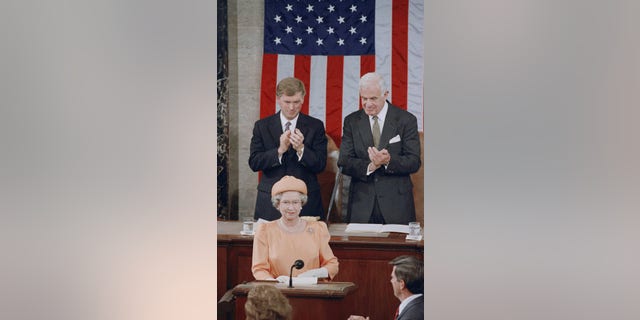 Queen Elizabeth II is applauded by Vice President Dan Quayle and House Speaker Thomas Foley before her address to the U.S. Congress on Thursday, May 16, 1991 in Washington. (AP Photo/Doug Mills)