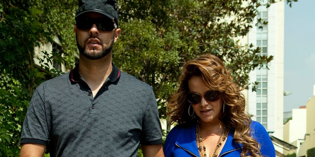 File picture taken on June 14, 2011, of Mexican-American singer Jenni Rivera, walking with her then boyfriend, baseball player Esteba Loaiza. Rivera died in a plane crash on December 9, 2012. AFP PHOTO (Photo credit should read STR/AFP via Getty Images)