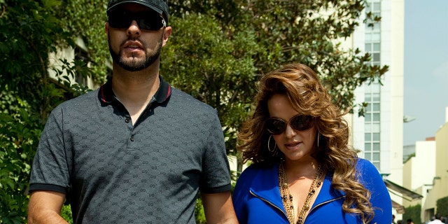 File picture taken on June 14, 2011, of Mexican-American singer Jenni Rivera, walking with her then boyfriend, baseball player Esteba Loaiza. Rivera died in a plane crash on December 9, 2012. AFP PHOTO (Photo credit should read STR/AFP via Getty Images)