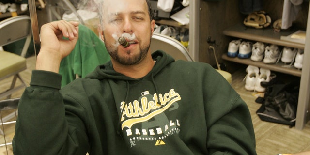 OAKLAND, CA - APRIL 14: Esteban Loaiza of the Oakland Athletics smokes a cigar in the clubhouse before the game against the New York Yankees at the McAfee Coliseum in Oakland, California on April 14, 2007. (Photo by Michael Zagaris/MLB Photos via Getty Images)