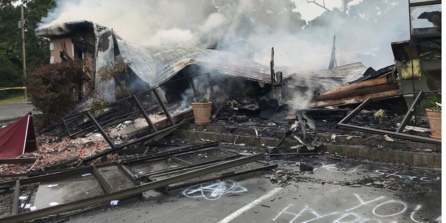 Embers smolder on the remains of the First Pentecostal Church in Holly Springs, Miss., May 20. (Major Kelly McMillen/Marshall County Sheriff's Office via AP)