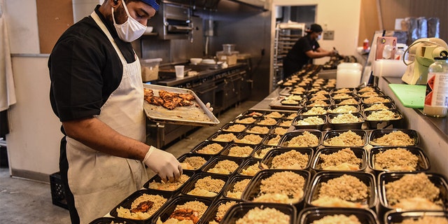 Employees work to create to-go donation meals for a company called Collective Fare in the Brownsville neighborhood in the Brooklyn borough in New York City. 