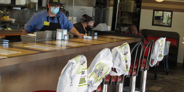 Plastic bags mark off seats to promote social distancing at a Waffle House restaurant in Savannah, Ga., on Monday, April 27, 2020. Restaurants statewide have been allowed to resume dine-in service with restrictions after a month of being limited to takeout meals only because of the coronavirus.