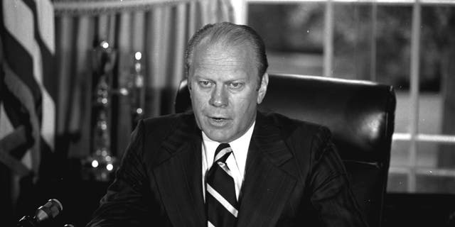 U.S. President Gerald Ford tells newsmen, Sunday, September 8, 1974, in his White House office that he has granted former President Richard M. Nixon 