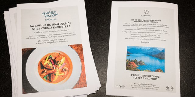 Flyers with special instructions about the take-way meal and advice from Chef Jean Sulpice are displayed in the Auberge du Pere Bise shop on April 19 in Talloires, France. Two Michelin Star chef Chef Jean Sulpice and his team are producing take-away meals for clients due to restaurant closures during France's lockdown.