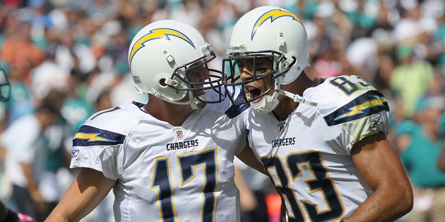Quarterback Philip Rivers #17 and wide receiver Vincent Jackson #83 of the San Diego Chargers celebrate after they hook up on a 55 yard touchdown pass in the first quarter against the Miami Dolphins at Qualcomm Stadium on September 25, 2011 in San Diego, California.
