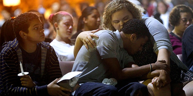 Faith Hedgepeth's boyfriend Alex Demery and her niece Alexis Evans gather with hundreds to remember Haliwa-Saponi tribe member and UNC student, Faith Hedgepeth, during a vigil, September 10, 2012, at UNC-Chapel Hill in Chapel Hill, North Carolina. Hedgepeth was found dead in her Chapel Hill apartment on September 7, 2012.