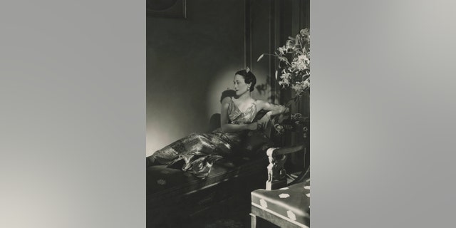 gardening The Duchess of Windsor wearing a gown, reclining on a chaise.