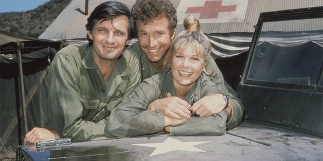 Portrait of, from left, American actors Alan Alda as Captain Benjamin Hawkeye Pierce, Wayne Roger as Captain Trapper John McIntyre and Loretta Swit as Major Margaret Houlihan, on the television series "M.A.S.H," California, 1972.