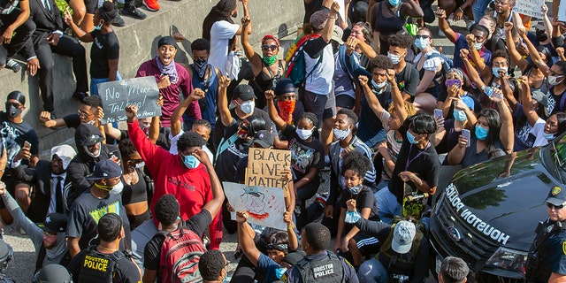 Protesters stop and chant "I can't breathe" as they march northbound on 288 just south of Tuam Street during a demonstration related to the death of George Floyd, a handcuffed black man who died Memorial Day while in the custody of the Minneapolis police, in Houston, Friday, May 29, 2020. (Mark Mulligan/Houston Chronicle via AP)