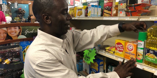 Burnell Cotlon stocks shelves in 'Burnell's Lower 9th Ward Market.' He's had to give away food to people in the community who are struggling to make it through the coronavirus pandemic. (Fox News/Charles Watson)
