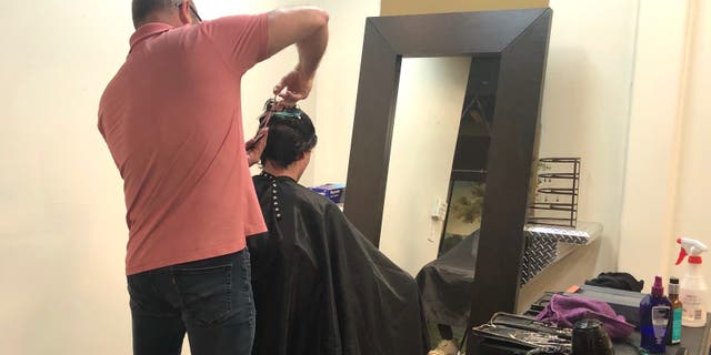 Hairstylist John Bryant reopens his salon and begins taking limited clients.